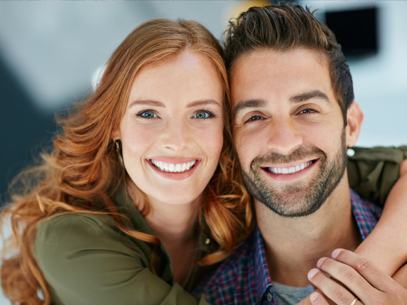 A woman and man cuddling and smiling